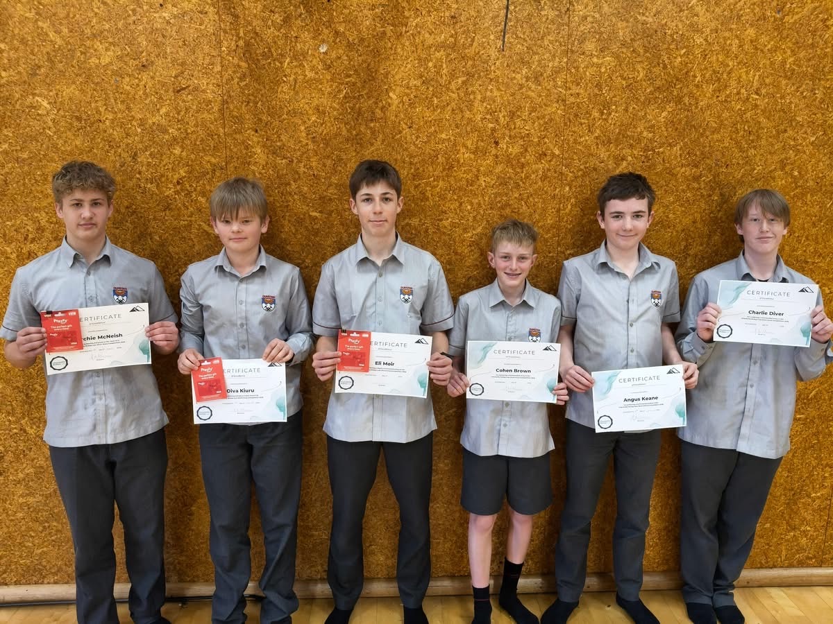 Six Dunstan High School students holding their competition certificates and prizes